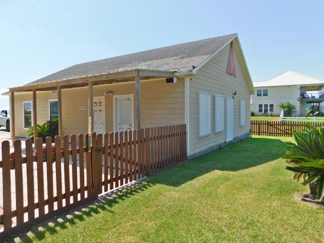 rear view of property featuring a lawn