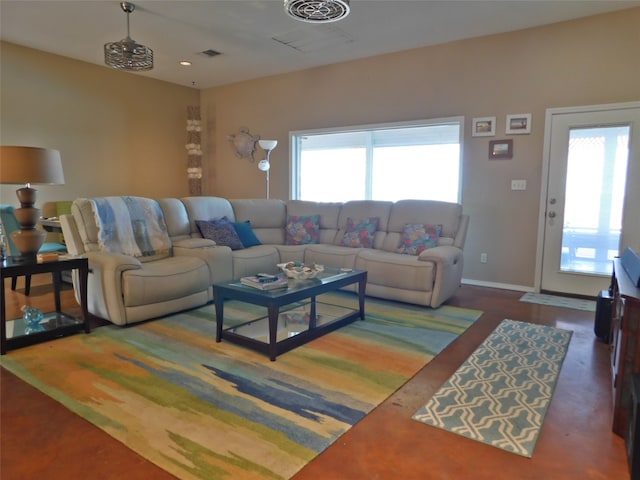 living room featuring a healthy amount of sunlight and dark hardwood / wood-style flooring