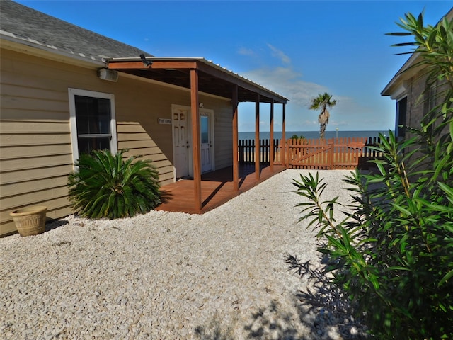 exterior space with a deck with water view and a patio area