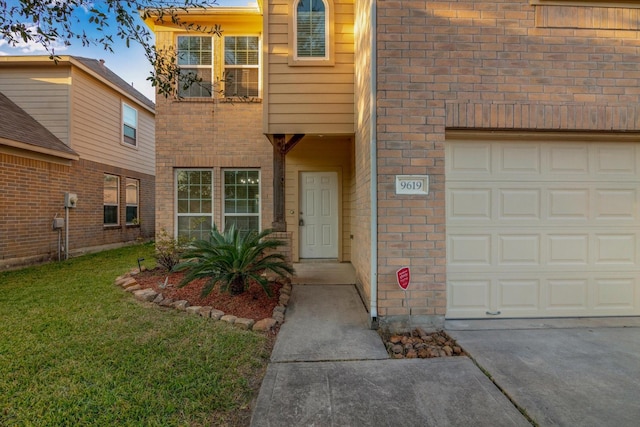 view of exterior entry with a lawn