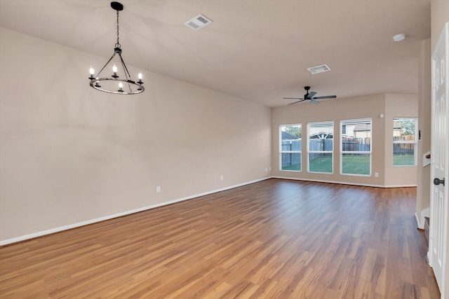 empty room featuring hardwood / wood-style floors and ceiling fan with notable chandelier