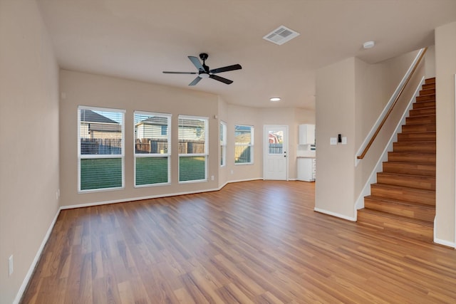 unfurnished living room with ceiling fan and wood-type flooring