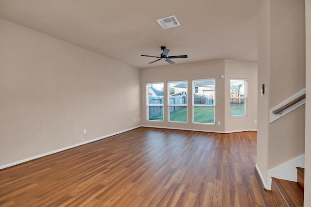 unfurnished living room with ceiling fan and dark wood-type flooring