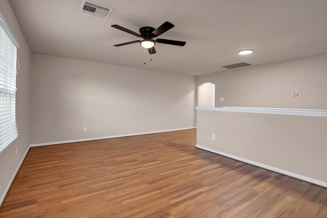 empty room featuring hardwood / wood-style flooring and ceiling fan