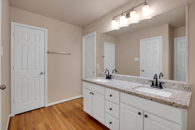 bathroom with hardwood / wood-style flooring and vanity