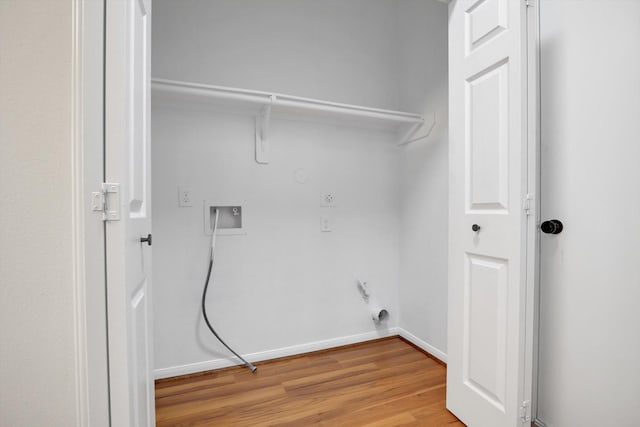 clothes washing area with light hardwood / wood-style floors and gas dryer hookup