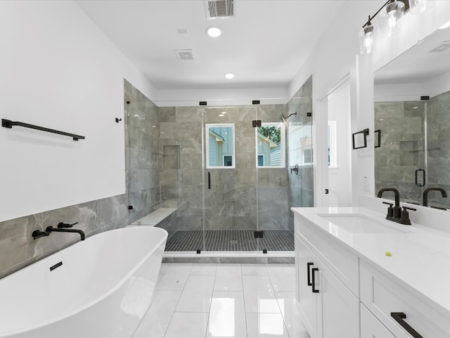 bathroom featuring vanity, independent shower and bath, and tile patterned flooring