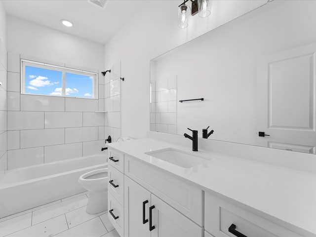 full bathroom with toilet, tiled shower / bath, vanity, and tile patterned flooring