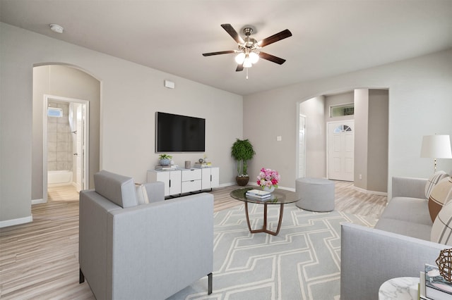 living room featuring light hardwood / wood-style flooring and ceiling fan