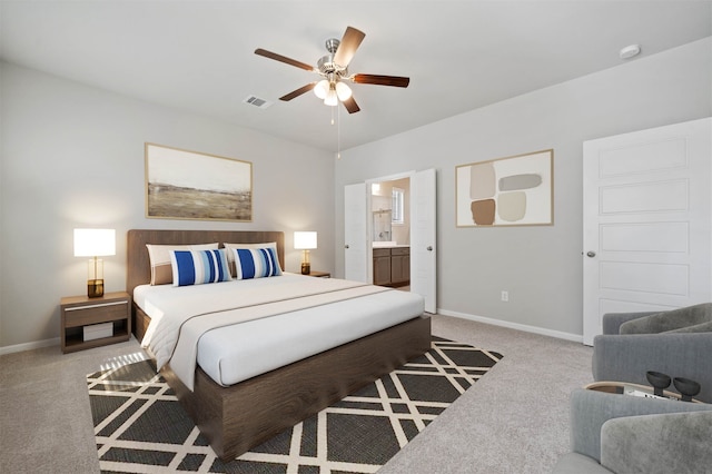 carpeted bedroom with connected bathroom and ceiling fan