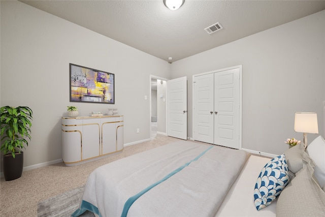 bedroom with carpet and a textured ceiling