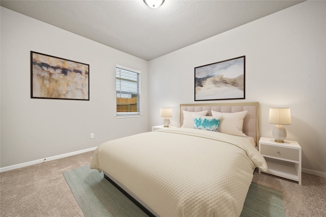 bedroom with carpet and a textured ceiling