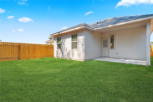 rear view of house featuring a lawn