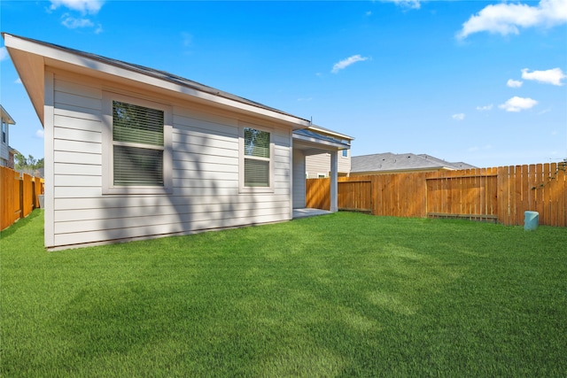 rear view of house with a yard