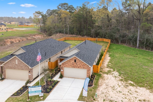 view of front of home with a garage and a front lawn