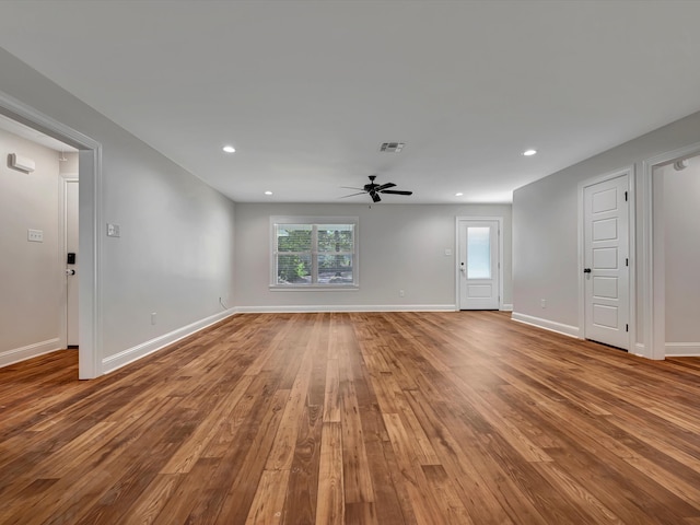 unfurnished living room with ceiling fan and hardwood / wood-style floors