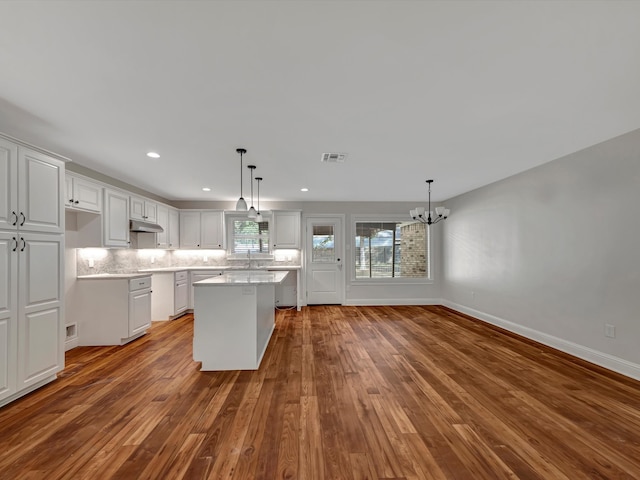 kitchen featuring white cabinetry, light hardwood / wood-style floors, and a center island