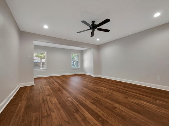 unfurnished room with ceiling fan and dark hardwood / wood-style flooring