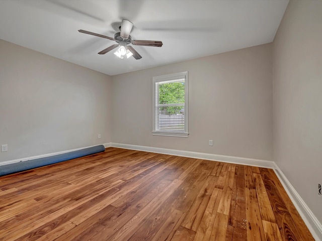 unfurnished room featuring ceiling fan and hardwood / wood-style floors