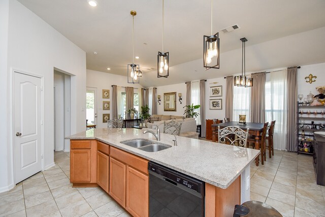 kitchen with black dishwasher, hanging light fixtures, an island with sink, a wealth of natural light, and sink