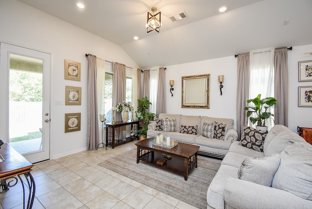 living room with light tile patterned floors and vaulted ceiling