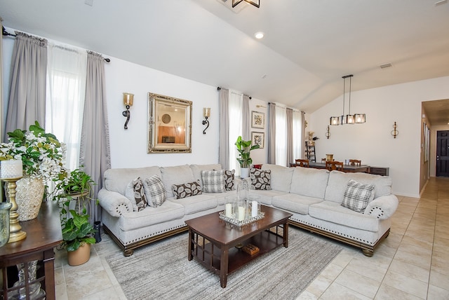 living room featuring light tile patterned flooring, vaulted ceiling, and an inviting chandelier