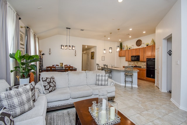 tiled living room featuring a notable chandelier