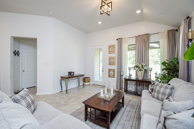 tiled living room featuring lofted ceiling and an inviting chandelier