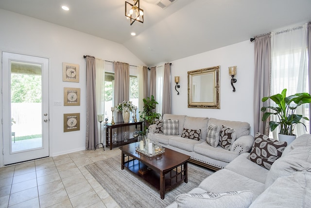 tiled living room featuring an inviting chandelier and vaulted ceiling