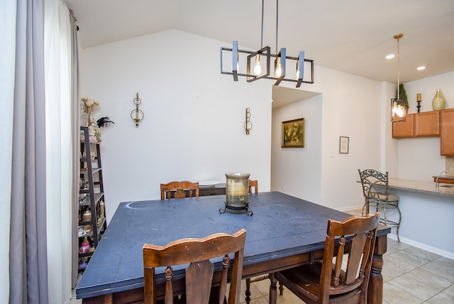 tiled dining space with a chandelier