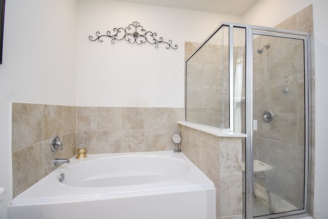 bathroom featuring shower with separate bathtub