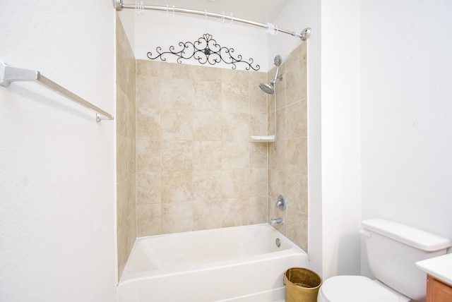 full bathroom featuring vanity, tiled shower / bath combo, and toilet