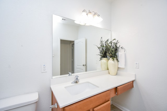 bathroom with toilet and vanity