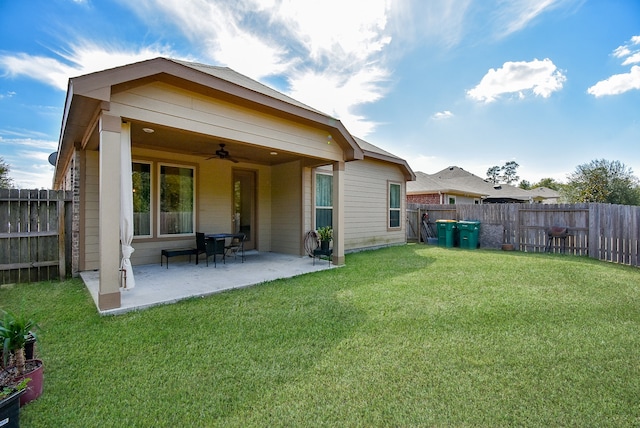 back of property with a patio, a lawn, and ceiling fan