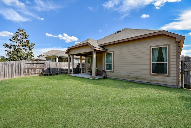 rear view of house with a patio area and a lawn