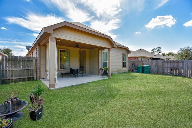 back of house featuring ceiling fan, a lawn, and a patio area