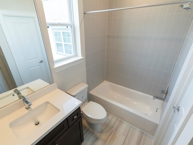 full bathroom with vanity, toilet, and tiled shower / bath combo