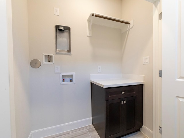 clothes washing area with light hardwood / wood-style flooring and hookup for a washing machine