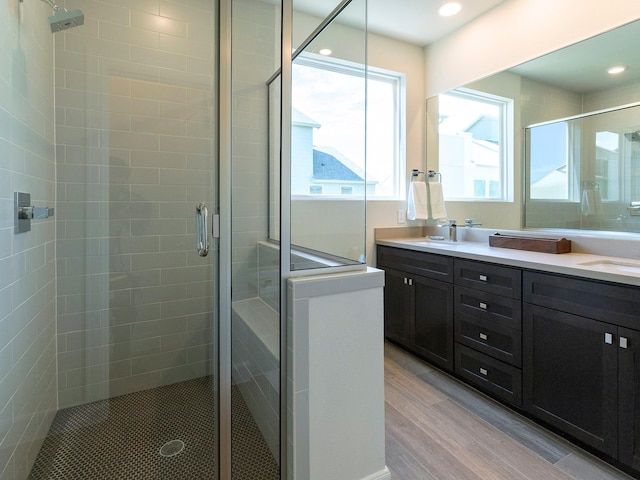 bathroom with vanity, an enclosed shower, and wood-type flooring