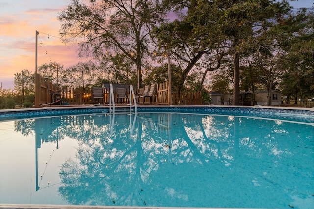 view of pool at dusk