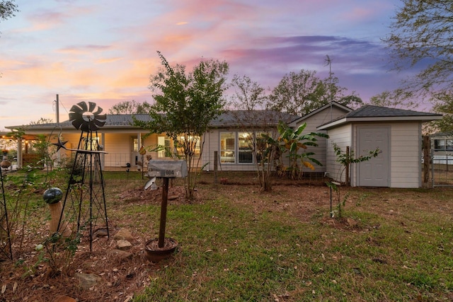 1726 Bowler Rd, Waller, TX 77484 - back of house at dusk with a yard and fence