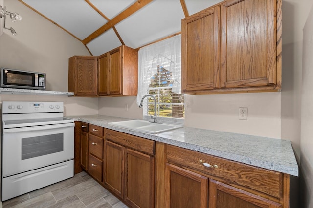 1726 Bowler Rd, Waller, TX 77484 - kitchen featuring a sink, stainless steel microwave, brown cabinets, light countertops, and electric range