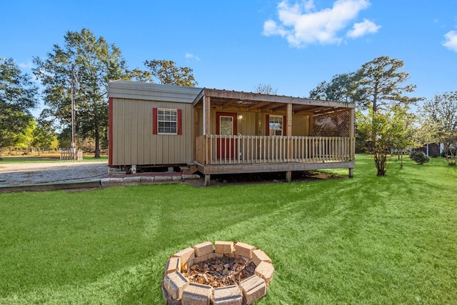 1726 Bowler Rd, Waller, TX 77484 - back of property with a yard and an outdoor fire pit
