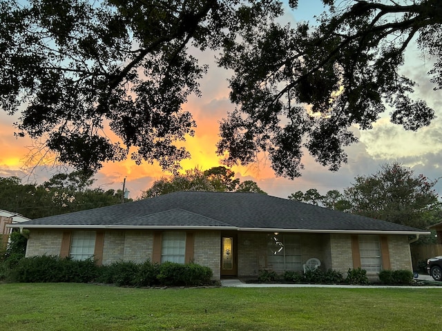 ranch-style house featuring a lawn