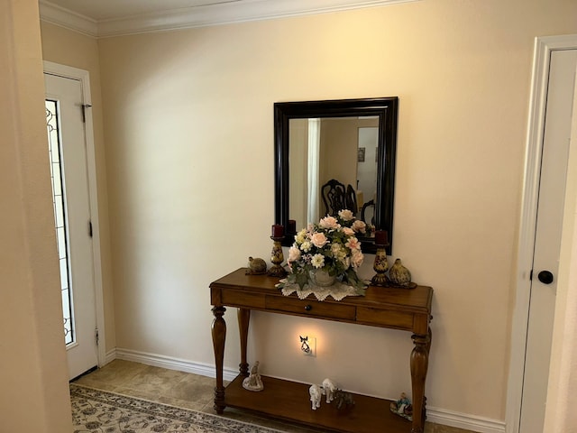 tiled foyer entrance featuring crown molding