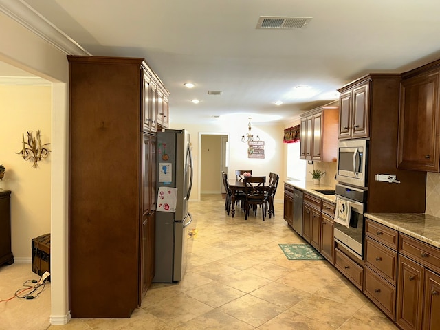 kitchen with backsplash, crown molding, and stainless steel appliances