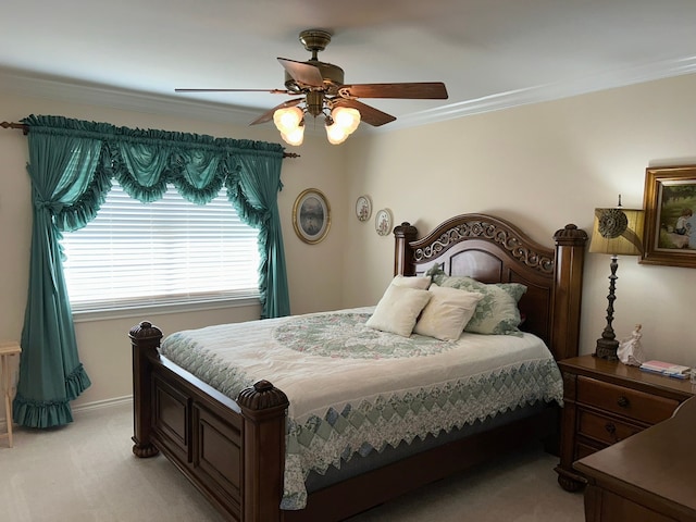 carpeted bedroom featuring ceiling fan and crown molding