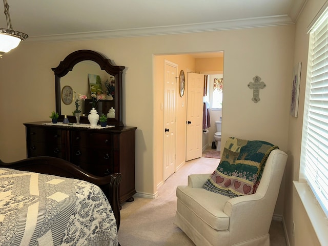 carpeted bedroom with ensuite bathroom and ornamental molding