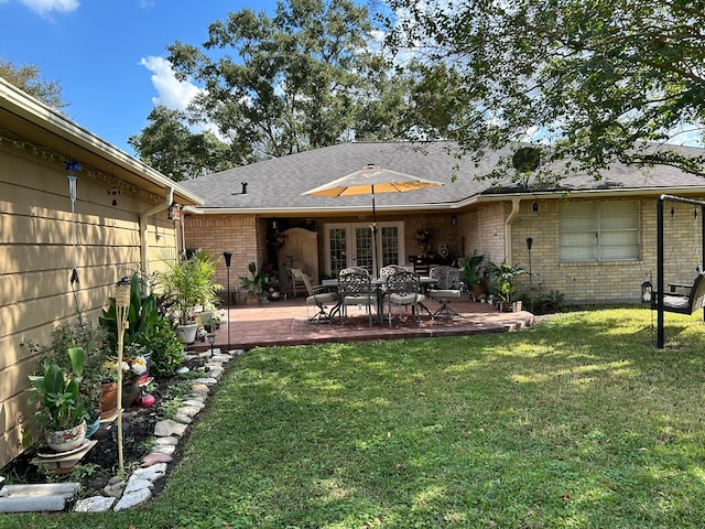 back of house with a yard and a patio area