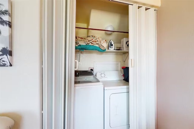 clothes washing area featuring washer and dryer